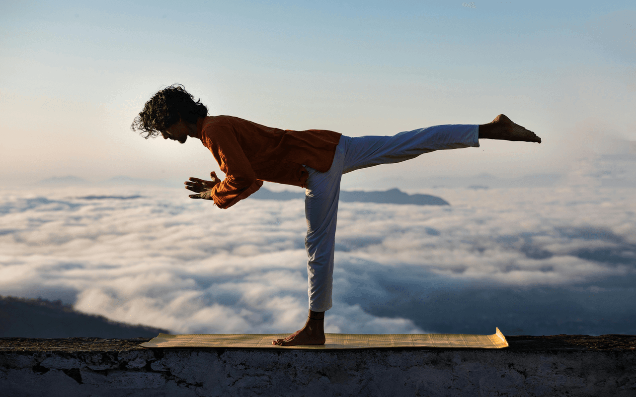 A person gracefully balancing on a rock